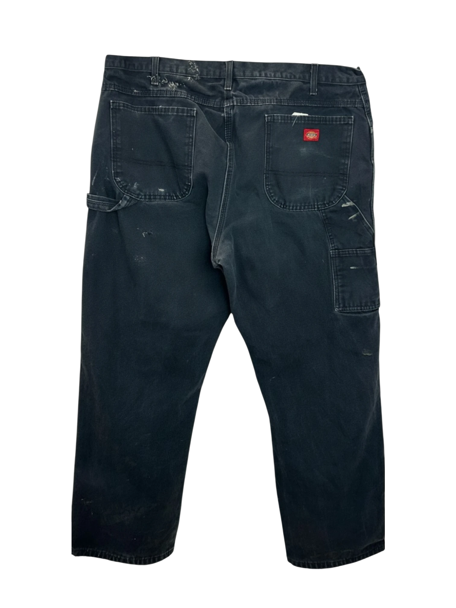 Lahad Vintage black distressed carpenter pants with paint splatters and multiple tool pockets.