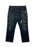 Lahad Vintage black distressed carpenter pants with paint splatters and multiple tool pockets.