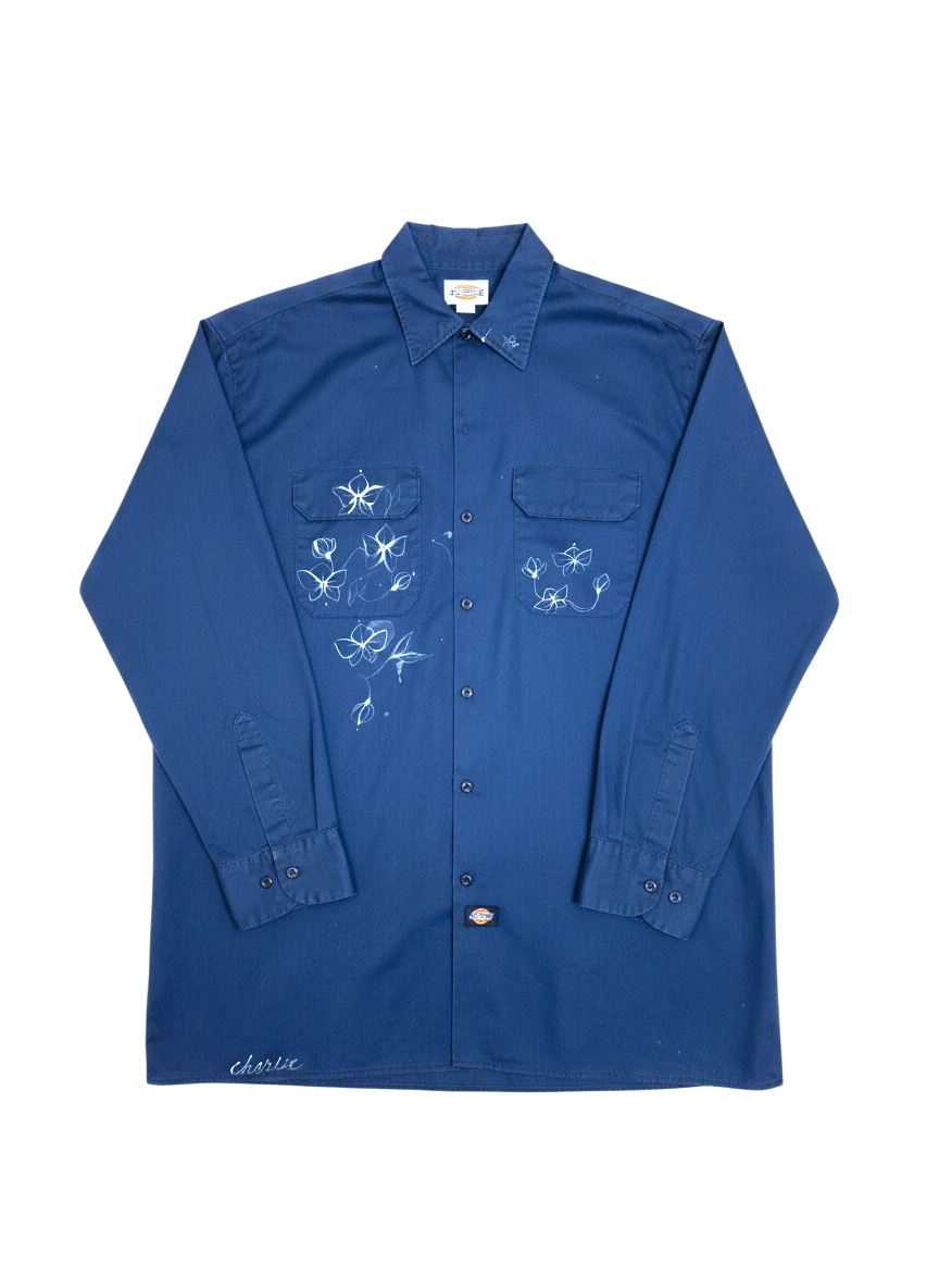 Lahad Vintage dark blue long-sleeve work shirt with embroidered white flowers and 'charlie' script on hem.