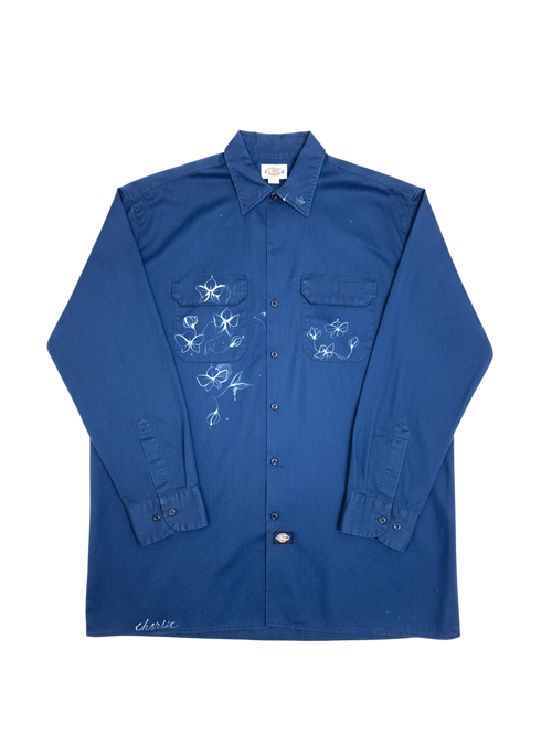 Lahad Vintage dark blue long-sleeve work shirt with embroidered white flowers and 'charlie' script on hem.