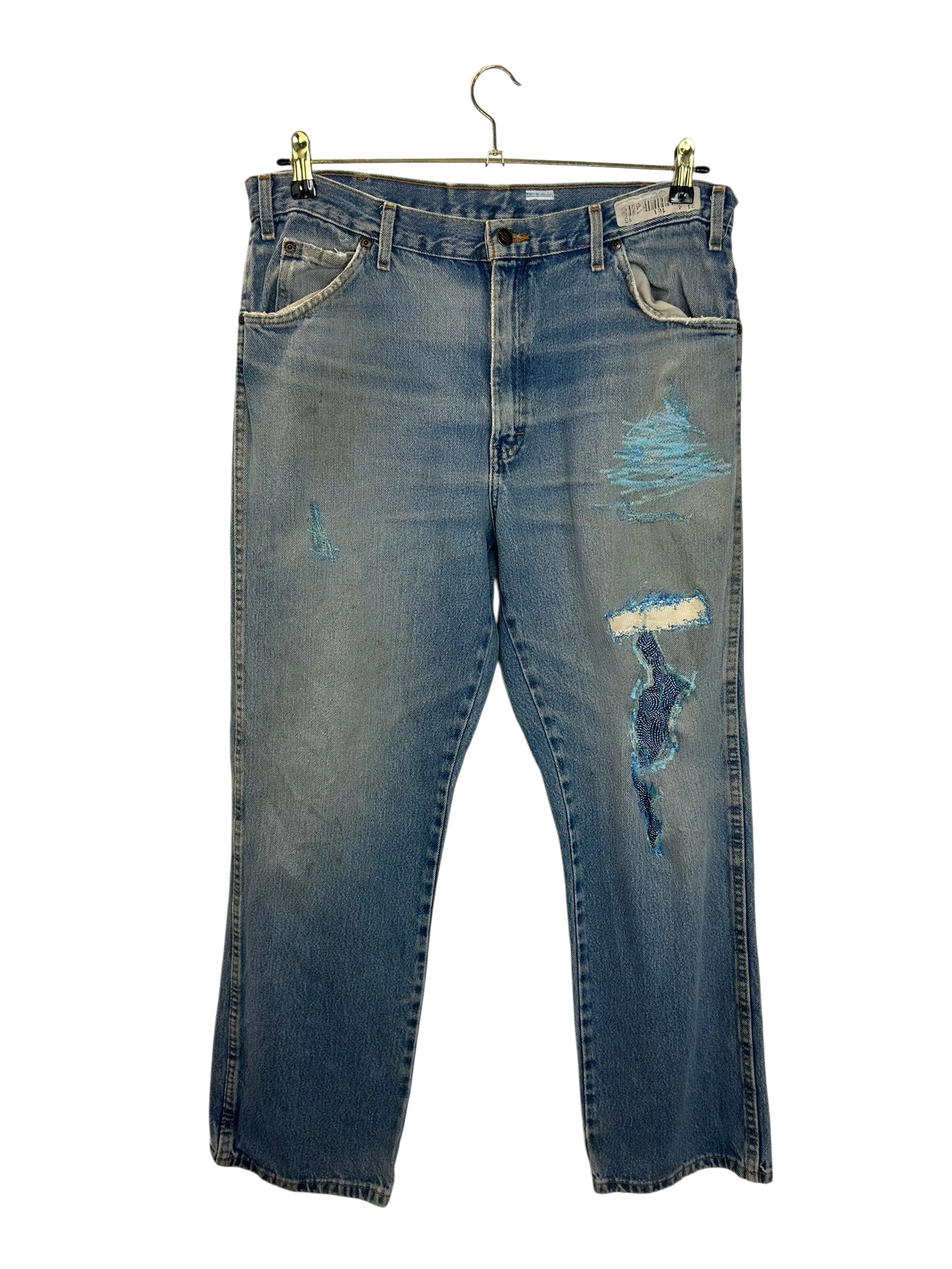 Lahad Vintage distressed light wash denim jeans with blue embroidery and ripped details.