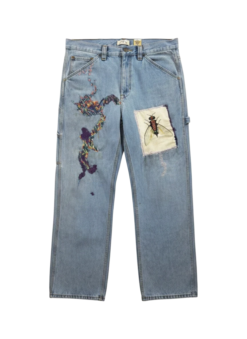 Lahad Vintage light-wash denim jeans with abstract rainbow embroidery and a fly patch. Custom art trousers.