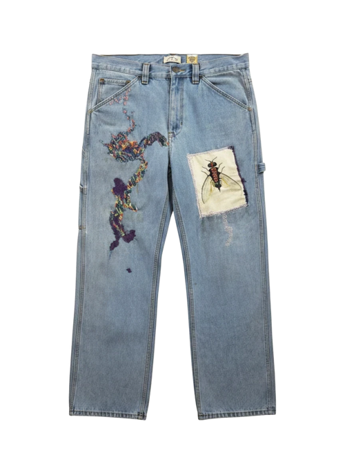 Lahad Vintage light-wash denim jeans with abstract rainbow embroidery and a fly patch. Custom art trousers.