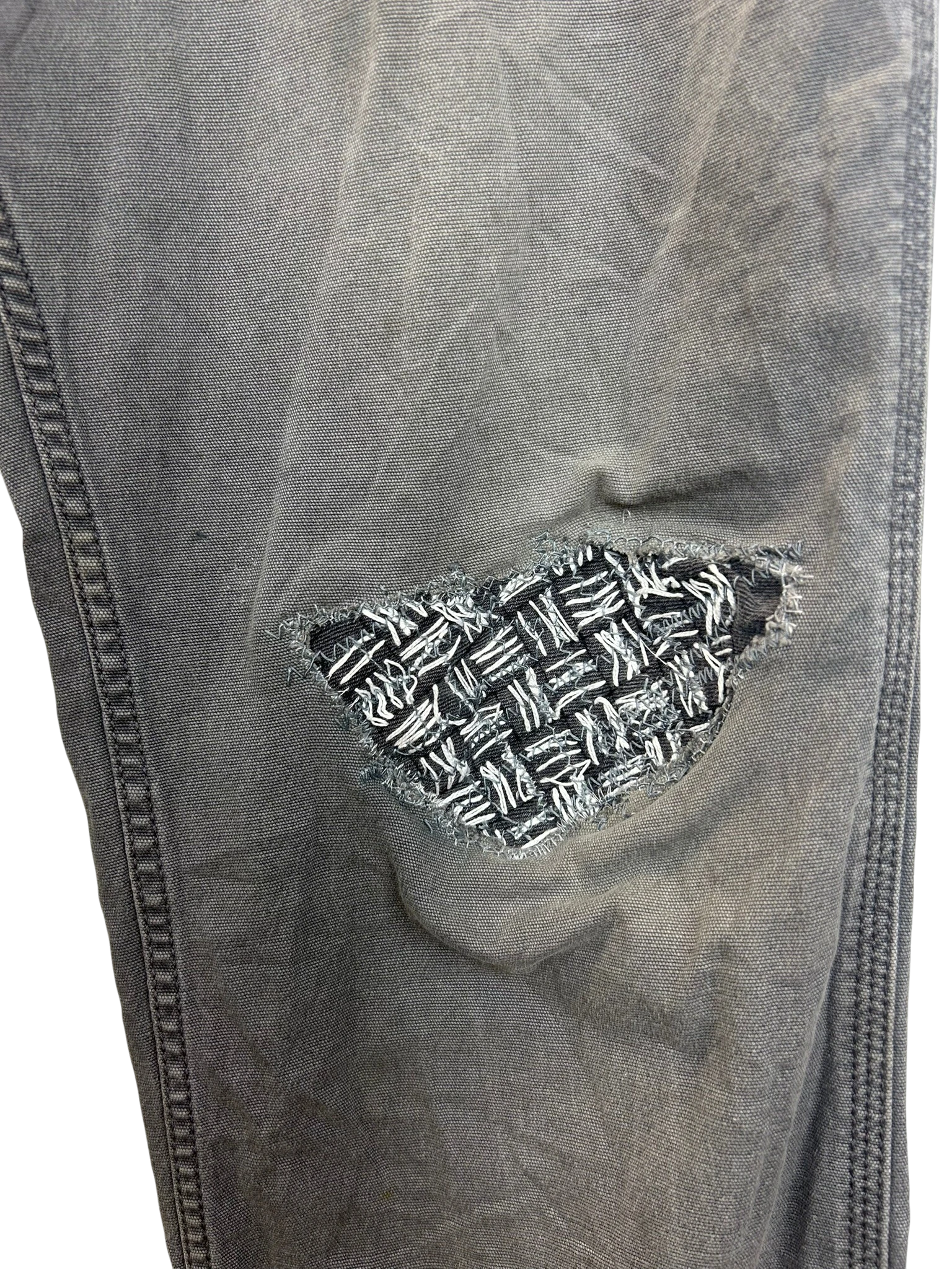 Lahad Vintage grey denim jeans with a unique woven patch repair on the knee.