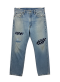 Lahad Vintage light wash denim jeans with distressed details and checkered patches on knees.