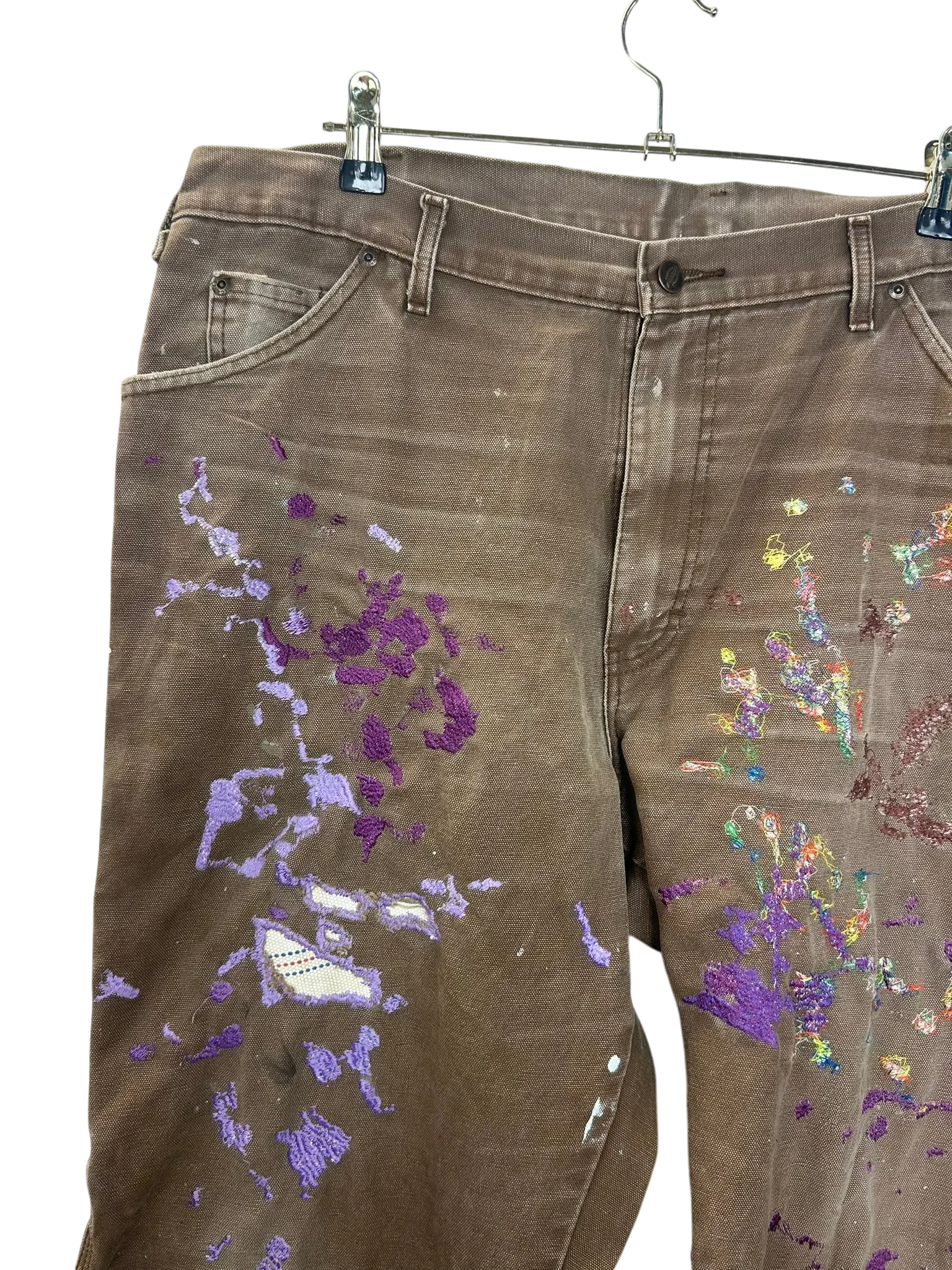 Lahad Vintage brown canvas carpenter pants with purple paint splatters and Metukan stitching detail.