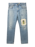 Lahad Vintage light-wash denim jeans with distressed details and a custom embroidered beetle patch on the right leg.