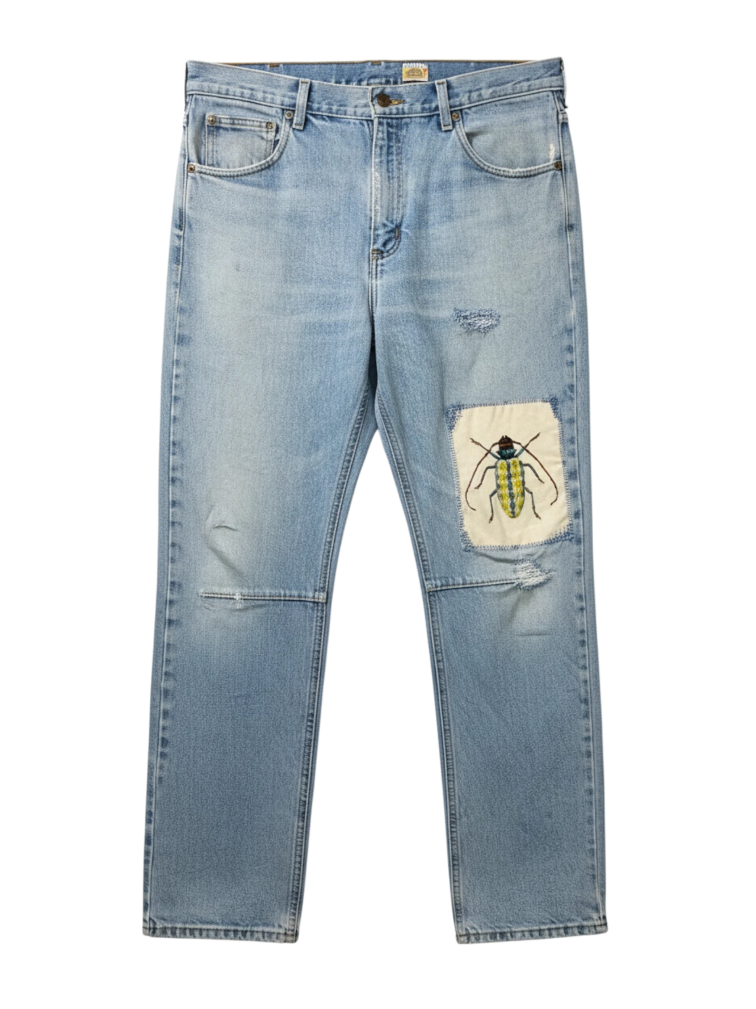 Lahad Vintage light-wash denim jeans with distressed details and a custom embroidered beetle patch on the right leg.