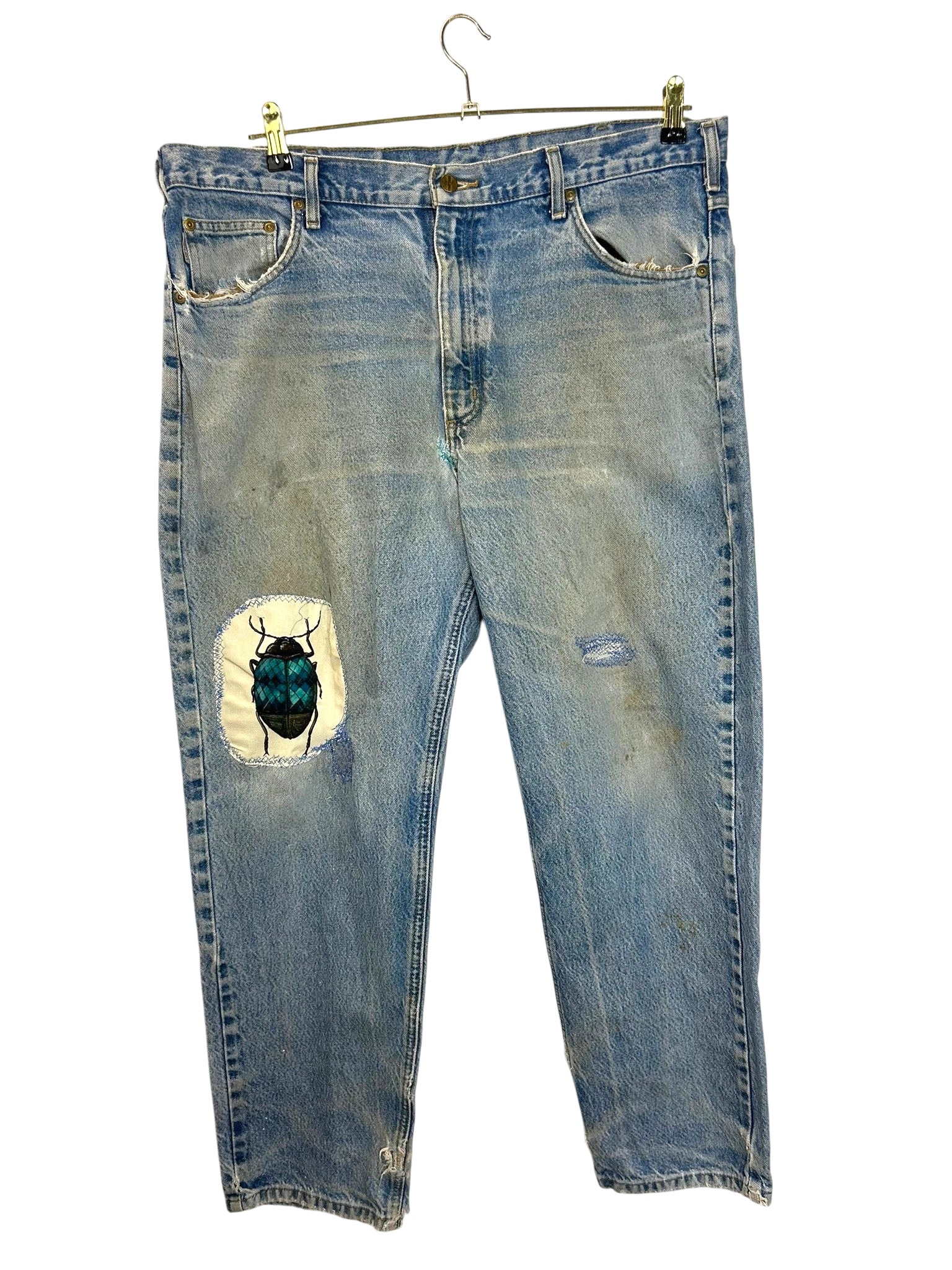 Lahad Vintage light-wash denim jeans with distressed details and a custom embroidered beetle patch on the left thigh.
