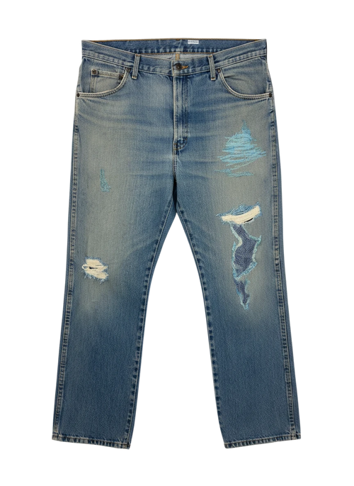 Lahad Vintage light wash denim jeans with distressed rips and blue embroidered patches on the legs.